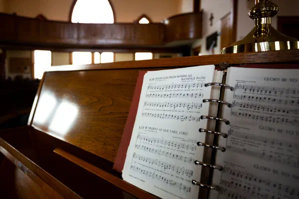 An open hymnal in the pew