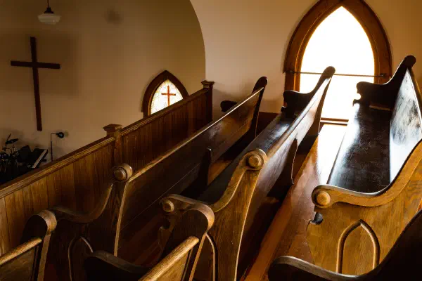 A pew end with the cross behind